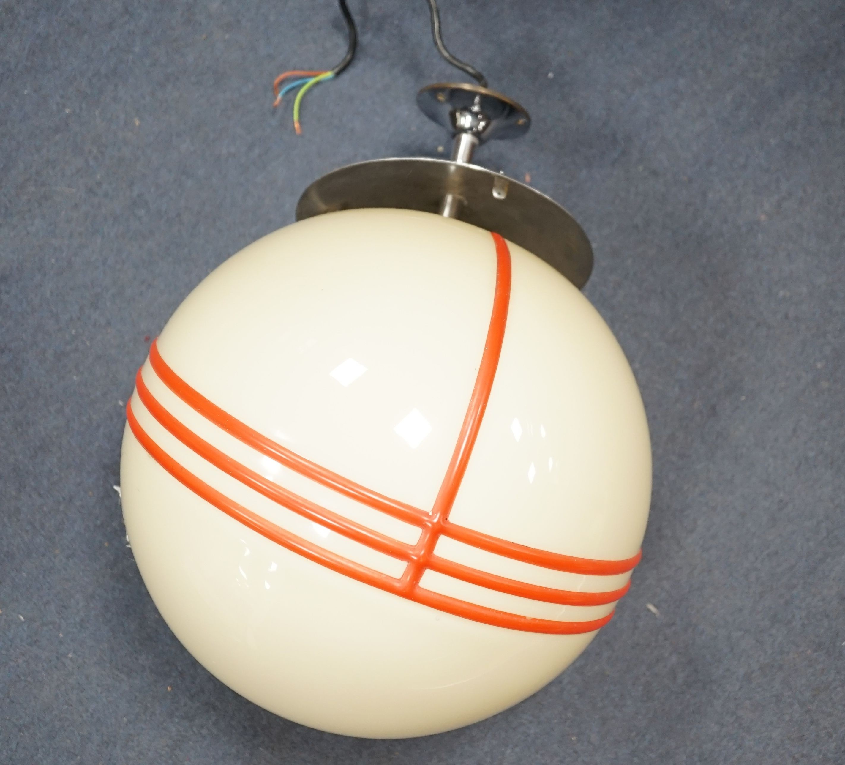 An Art Deco style chrome and cream globular shaded ceiling light with orange trailed decoration, probably 1930s